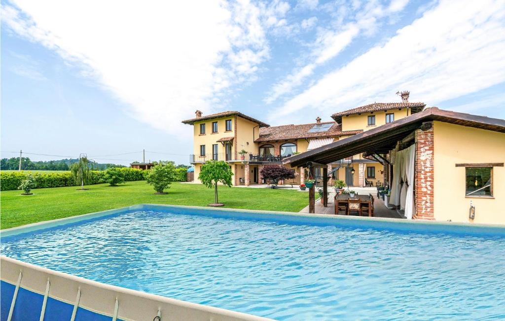a large swimming pool in front of a house at 4 Bedroom Lovely Home In Lequio Tanaro in Lequio Tanaro