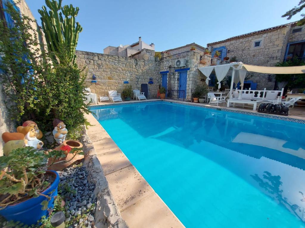 a swimming pool in front of a house at 1882 Hotel in Alaçatı