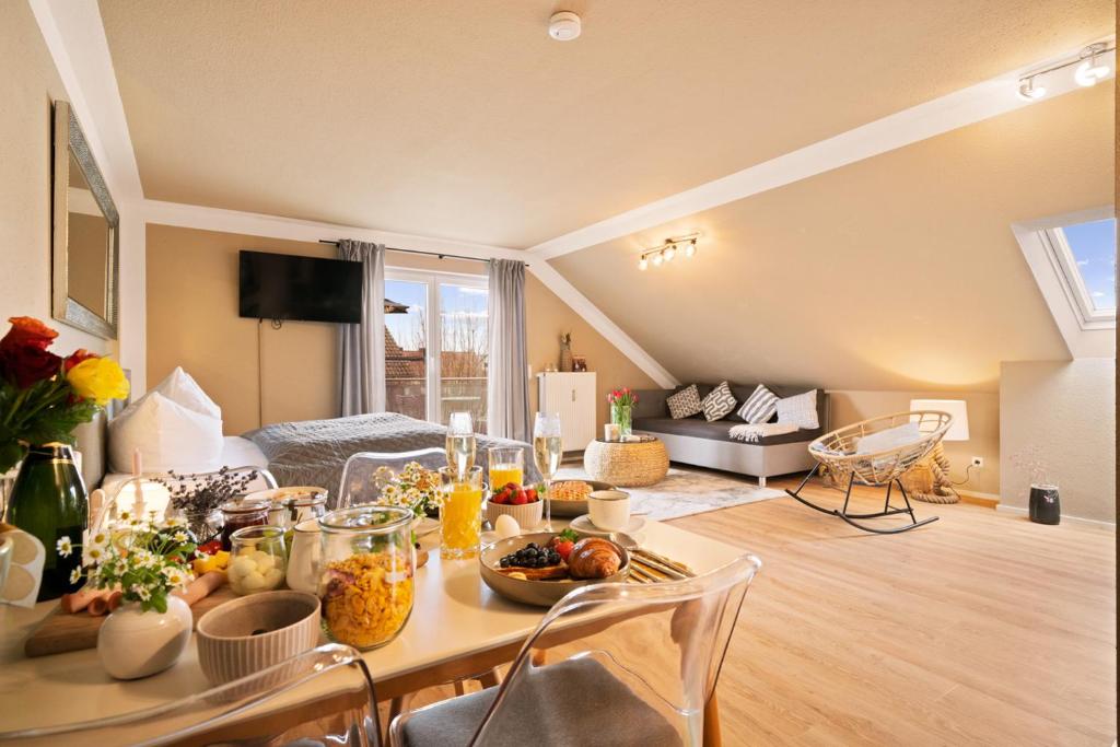 a living room with a table with food on it at Ferien-Apartment Seewiesen - mit priv Strandzugang in Friedrichshafen