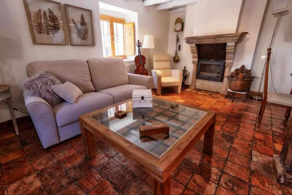 a living room with a couch and a coffee table at Casa Rural La Chascona in Pedrajas