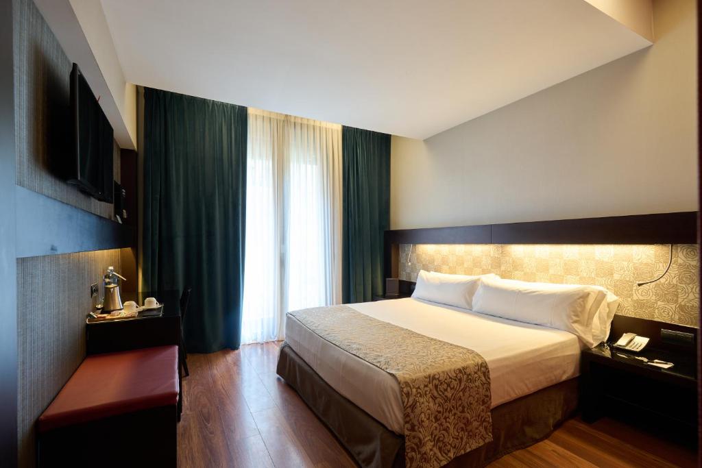 a hotel room with a bed and a window at Catalonia Port in Barcelona
