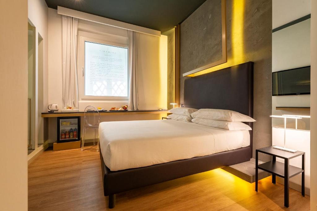 a bedroom with a large bed and a window at Maison Pellegrino in Rome