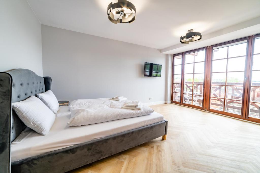 Posteľ alebo postele v izbe v ubytovaní Apartamenty Mazurskie