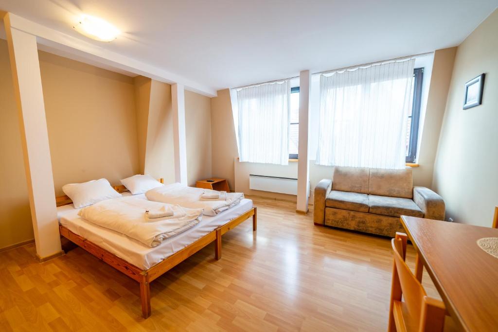 Posteľ alebo postele v izbe v ubytovaní Apartamenty Mazurskie