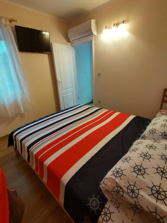 a small bedroom with a bed and a window at Apartment RELAX in Tsarevo in Tsarevo