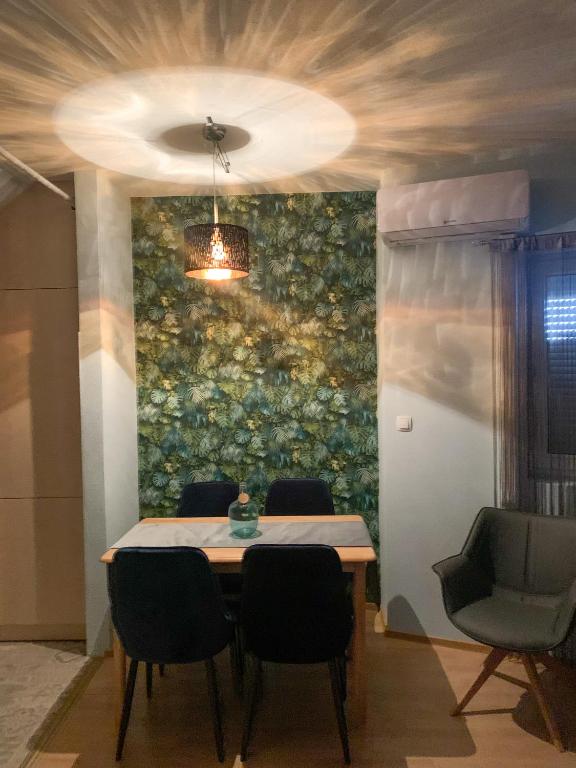 a dining room with a table and chairs and a wall at Rooftop Corner Siófok in Siófok