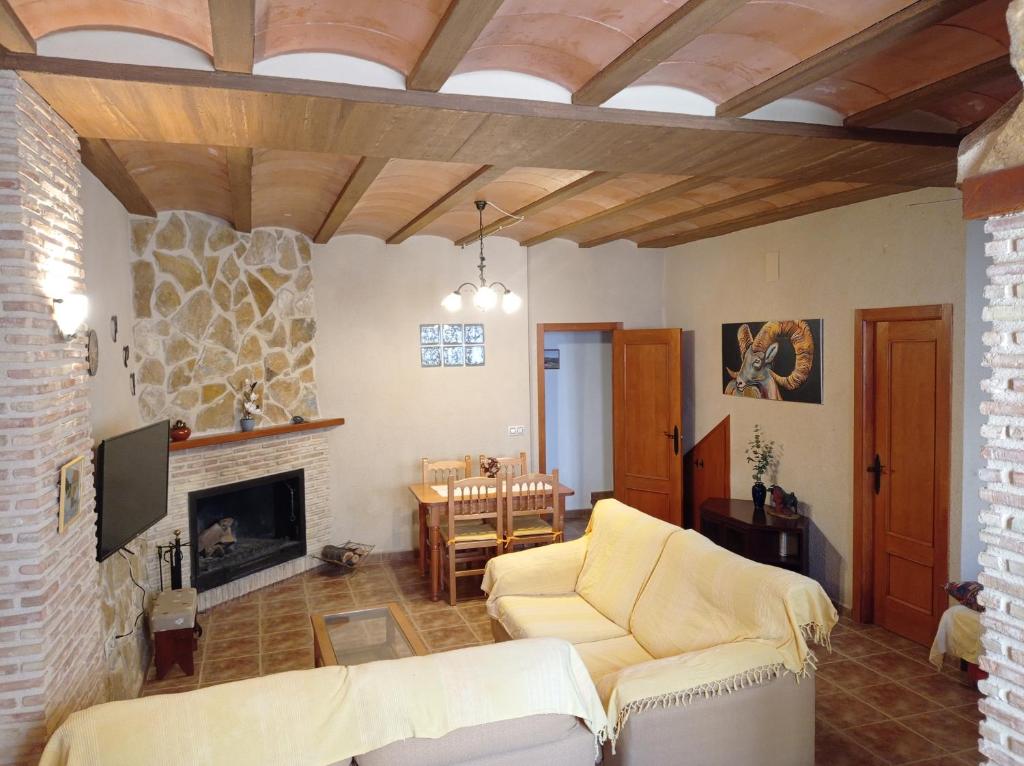 a living room with a couch and a fireplace at Casa Camille.Villares Elche de la Sierra in Elche de la Sierra