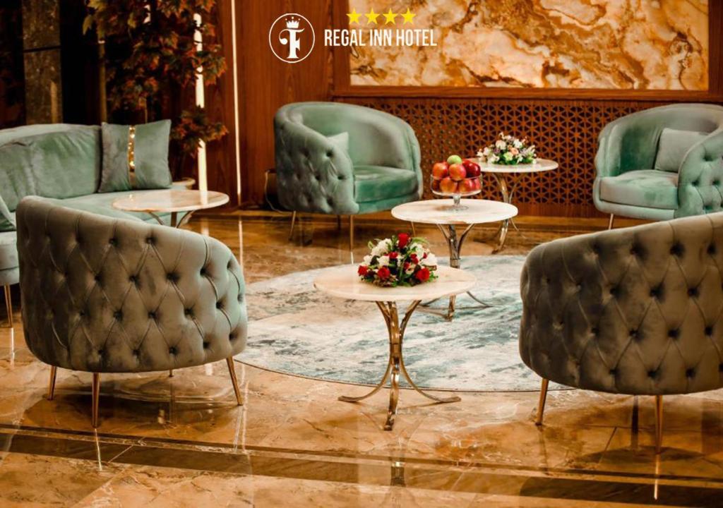 a lobby with couches and tables and chairs at Regal Inn Badamdar Hotel in Baku