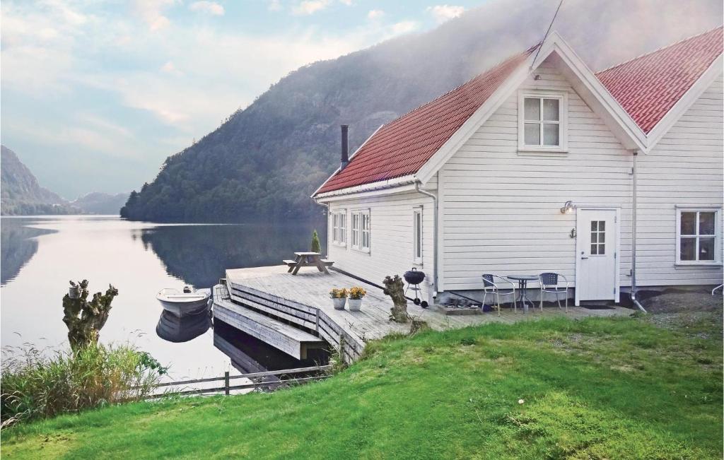 a house on a dock next to a body of water at Stunning Home In Flekkefjord With House Sea View in Flekkefjord