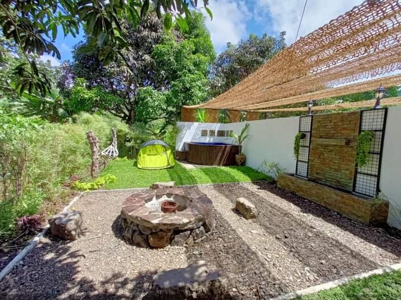 a backyard with a fire pit and a tent at Casa de Cortijo in Pagbilao