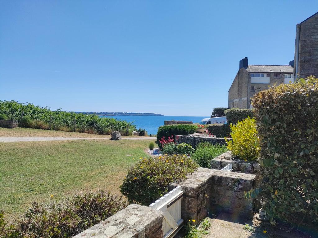 widok na ogród z oceanem w tle w obiekcie REF 047 - Bel appartement moderne pour six personnes avec vue mer plage à pied KERJOUANNO ARZON w mieście Arzon