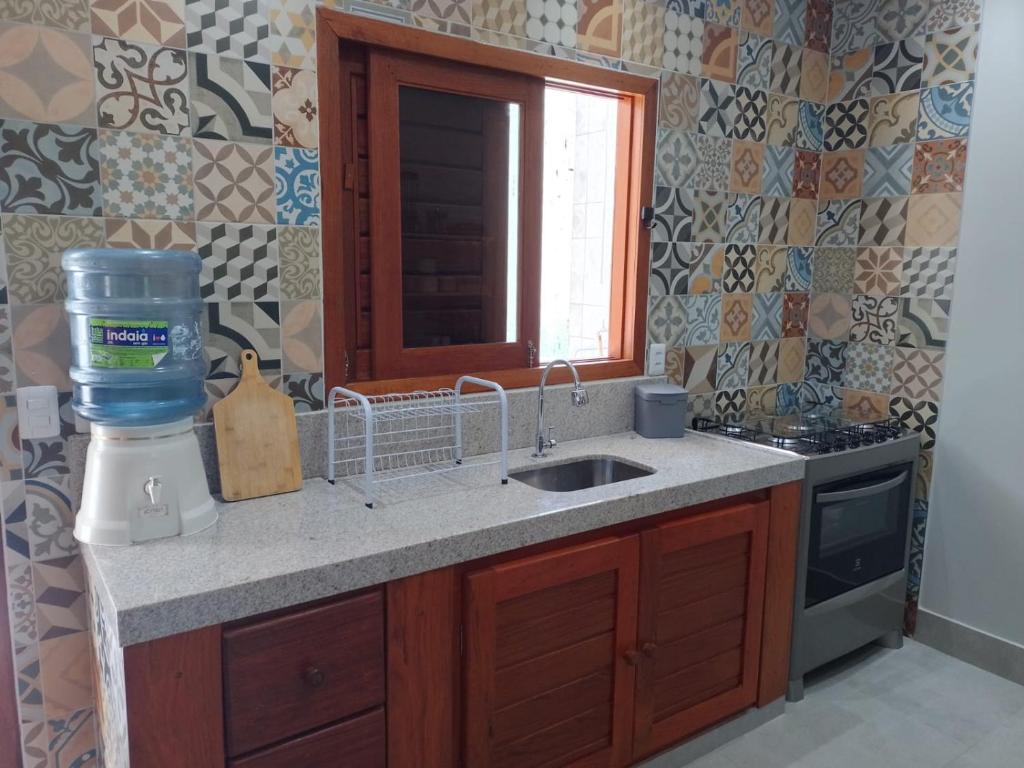 un bancone della cucina con lavandino e finestra di Casa Verde Maré a Pipa