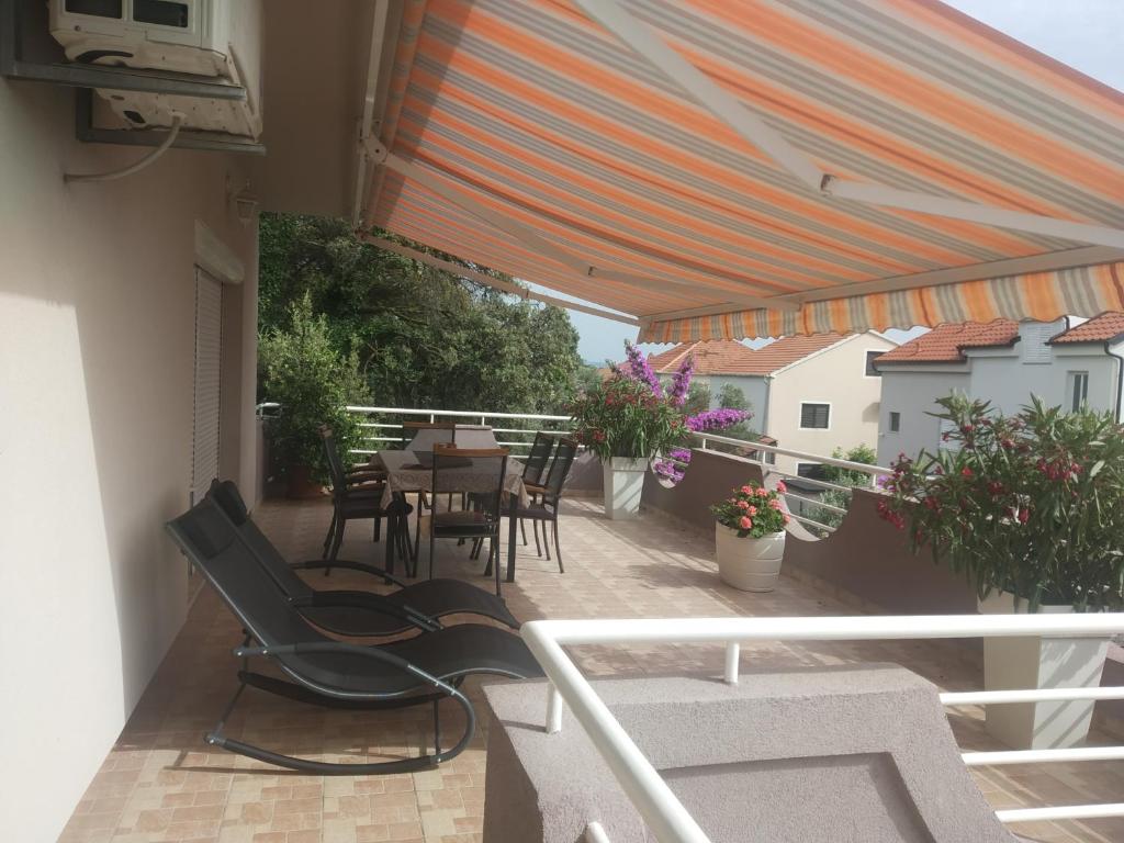 a patio with a table and chairs on a balcony at Apartments Adrian in Bibinje