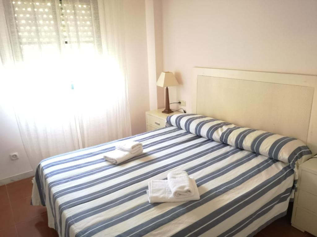 Postel nebo postele na pokoji v ubytování PLANTA BAJA ACCESO DIRECTO A LA PLAYA