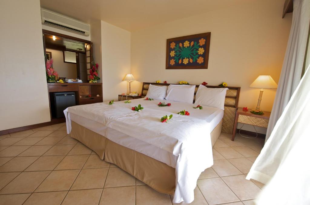 Uma cama ou camas num quarto em Maitai Bora Bora