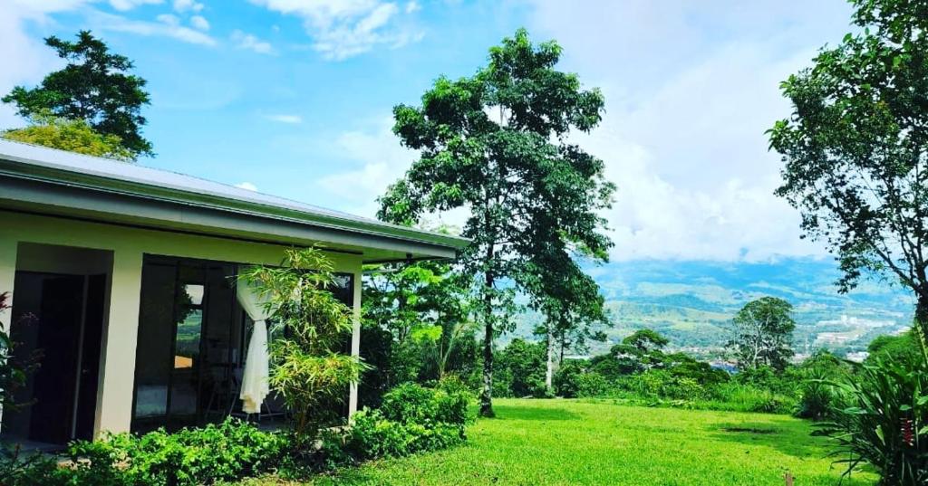 a house with a view of a green field at Koi Room in Quesada