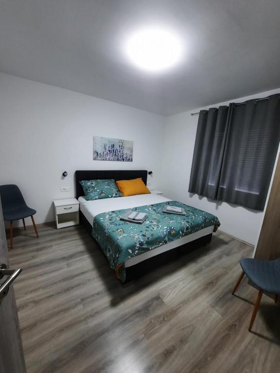a bedroom with a bed and a table and chairs at Apartmani Gabrijel in Novi Vinodolski