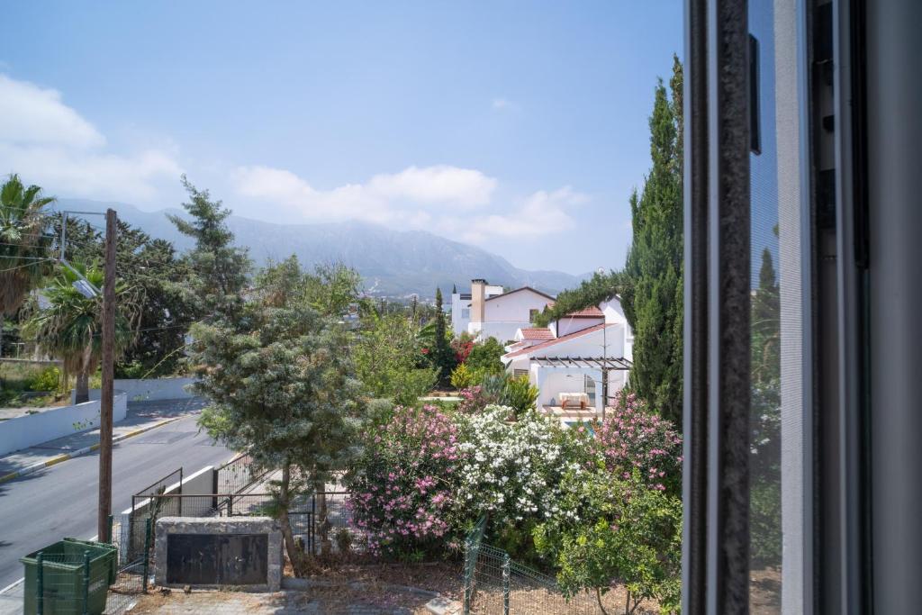 a view from a window of a street with flowers at Beautiful Two-bedroom Apartment with Sea and Mountain views Sel 8-5 in Kyrenia