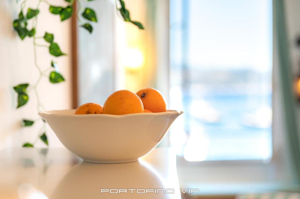 a bowl of oranges sitting on a table at San Giorgio by PortofinoVip in Portofino
