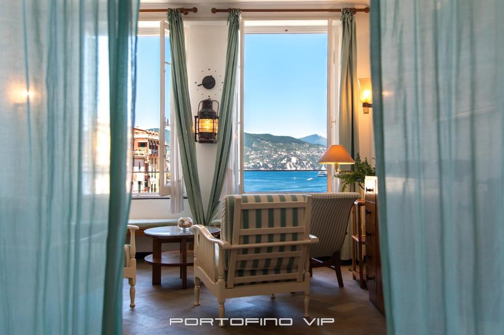 a room with a window with a view of the ocean at San Giorgio by PortofinoVip in Portofino