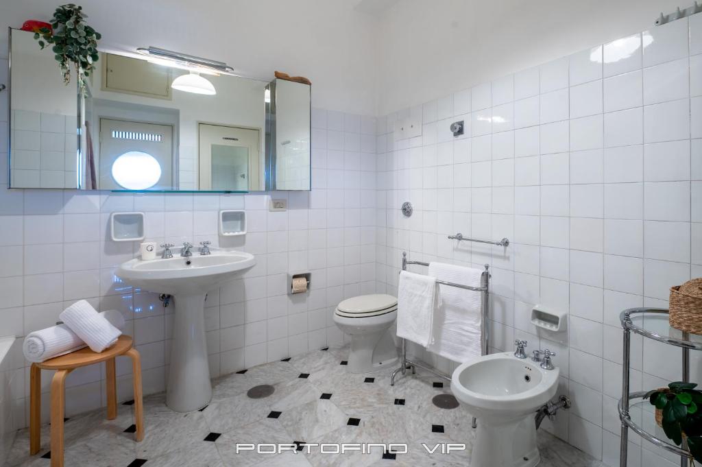 a bathroom with a sink and a toilet and a mirror at San Giorgio by PortofinoVip in Portofino
