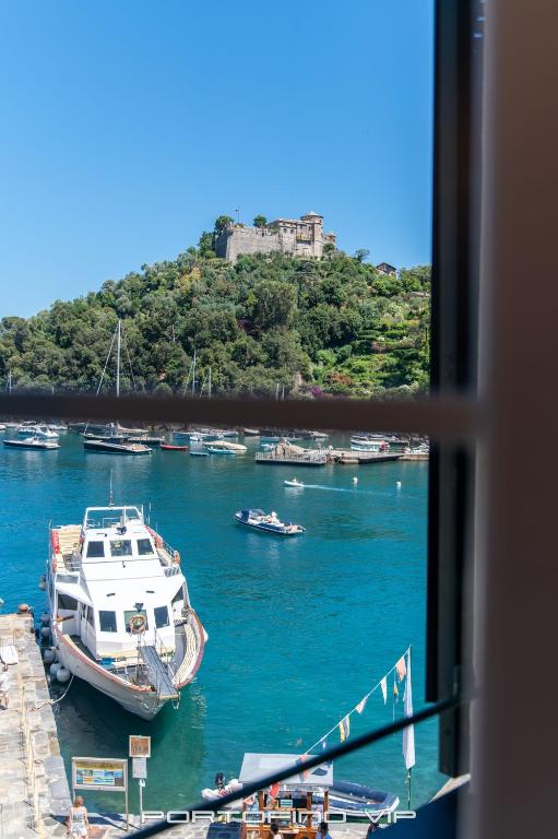 a view from a window of a boat in a harbor at San Giorgio by PortofinoVip in Portofino