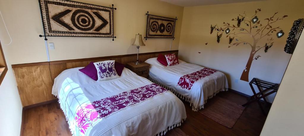 Postel nebo postele na pokoji v ubytování Quinta Tere Hotel & Gallery
