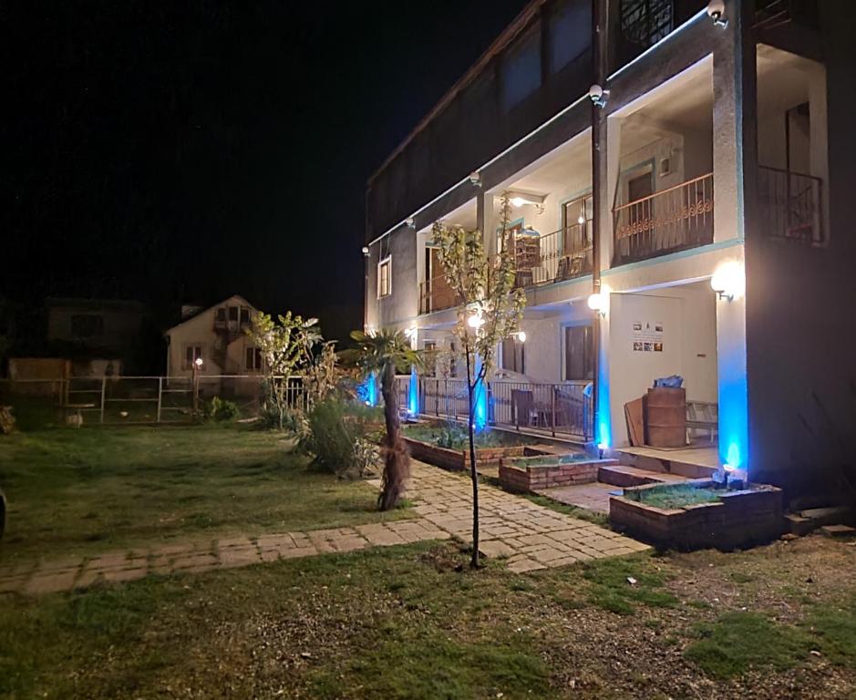 a house at night with blue lights on it at Apsa Butik Hotel in Sukhum