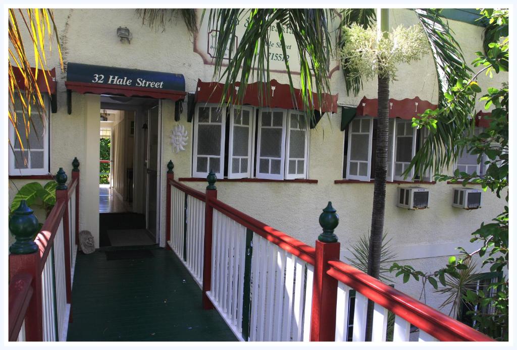 a house with a red fence and a porch at Coral Lodge Bed and Breakfast Inn in Townsville