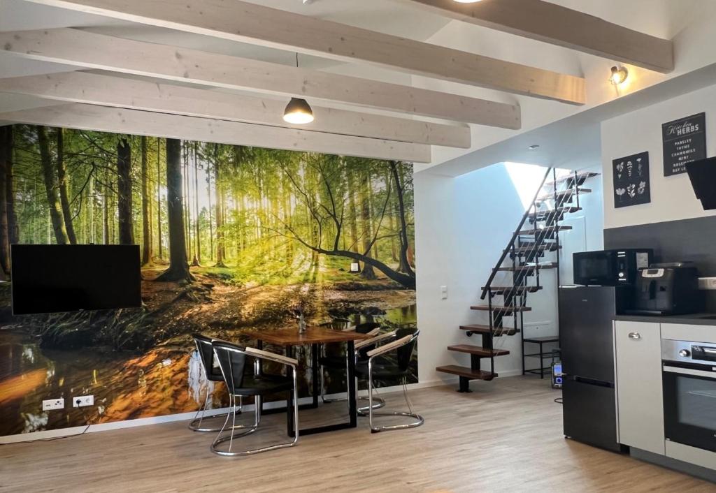 a kitchen with a wall mural of a forest at Loft Wohnung Appartement auf 2 Etagen, Nähe Neckar in Neckarwestheim