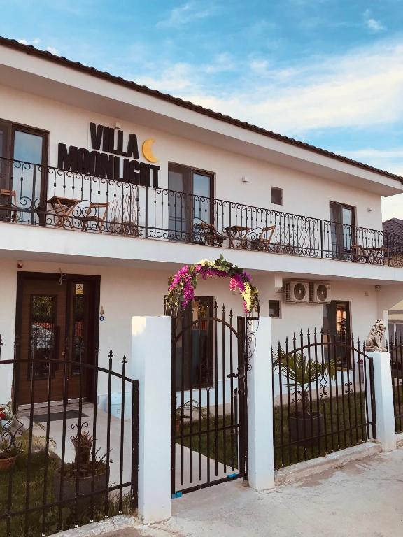 a white building with a wrought iron fence at Casa Moonlight 2 Mai in 2 Mai