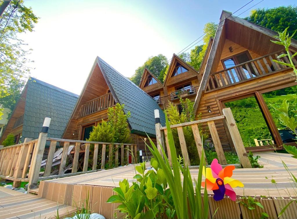 a wooden house with a flower on the front porch at ELASYA BUNGALOV in Rize