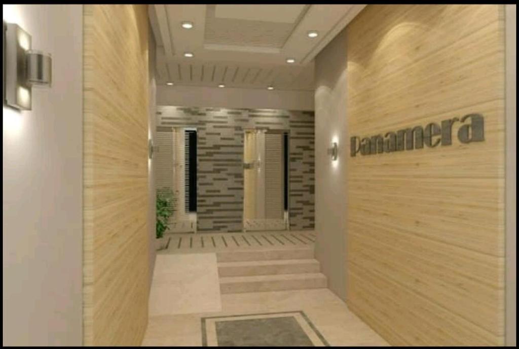 a hallway of a building with a sign on the wall at Apartment Haut standing Panamera Residence Khezema Sousse in Sousse