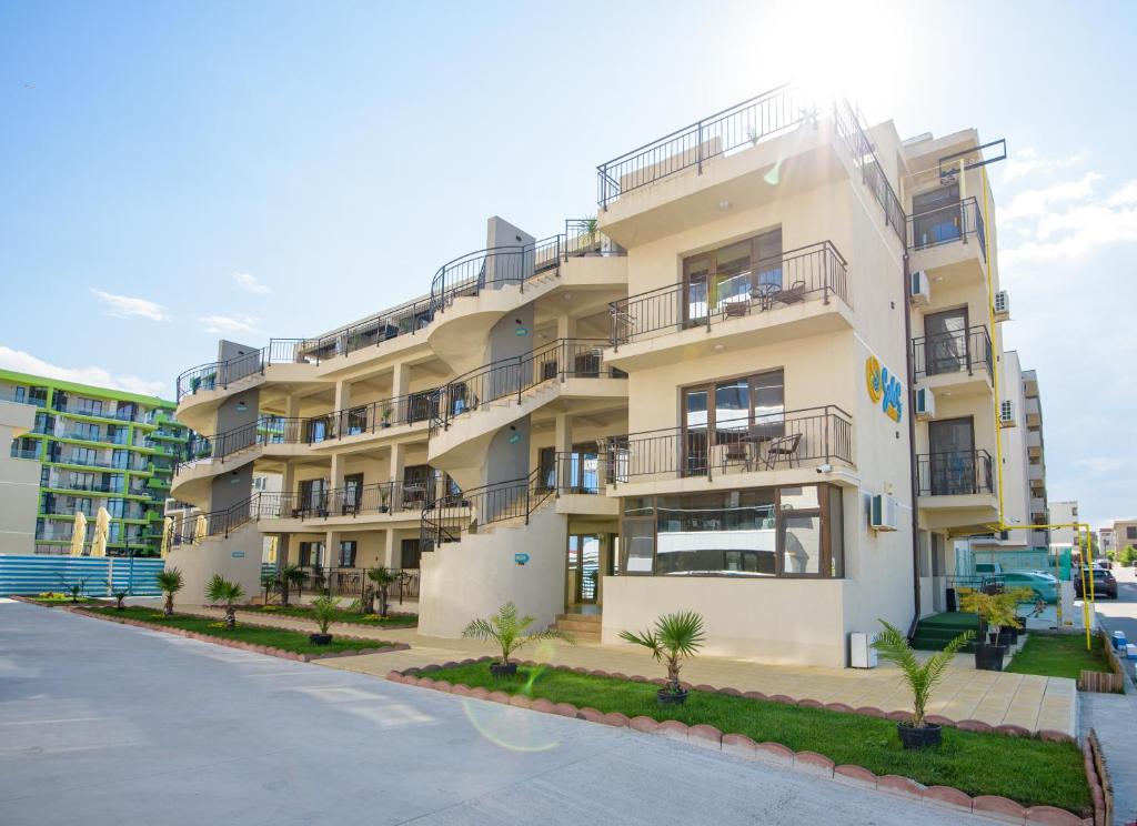 an apartment building with balconies and a parking lot at SaloS Beach Resort in Mamaia Sat/Năvodari