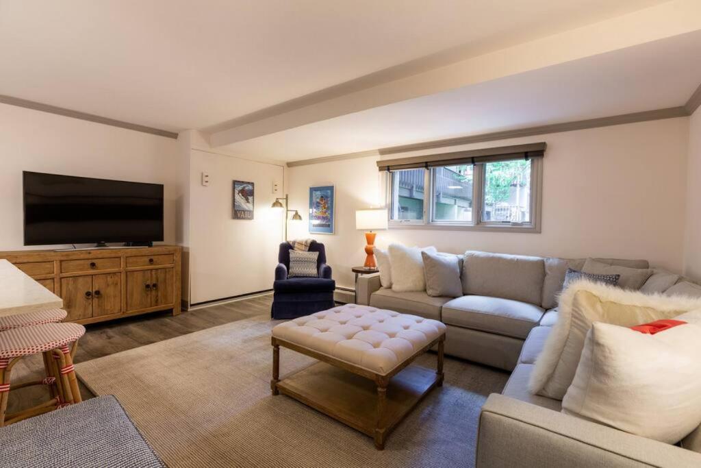 a living room with a couch and a tv at Convenience and Style, Two Q Beds in Vail