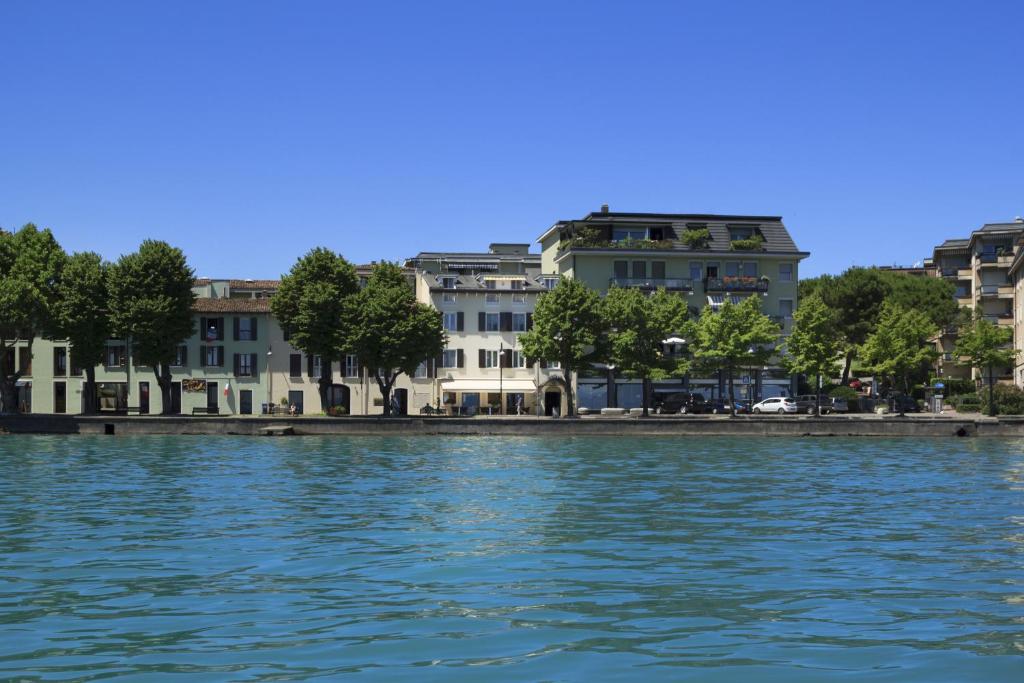 a view of a city from the water at Hotel Europa in Desenzano del Garda