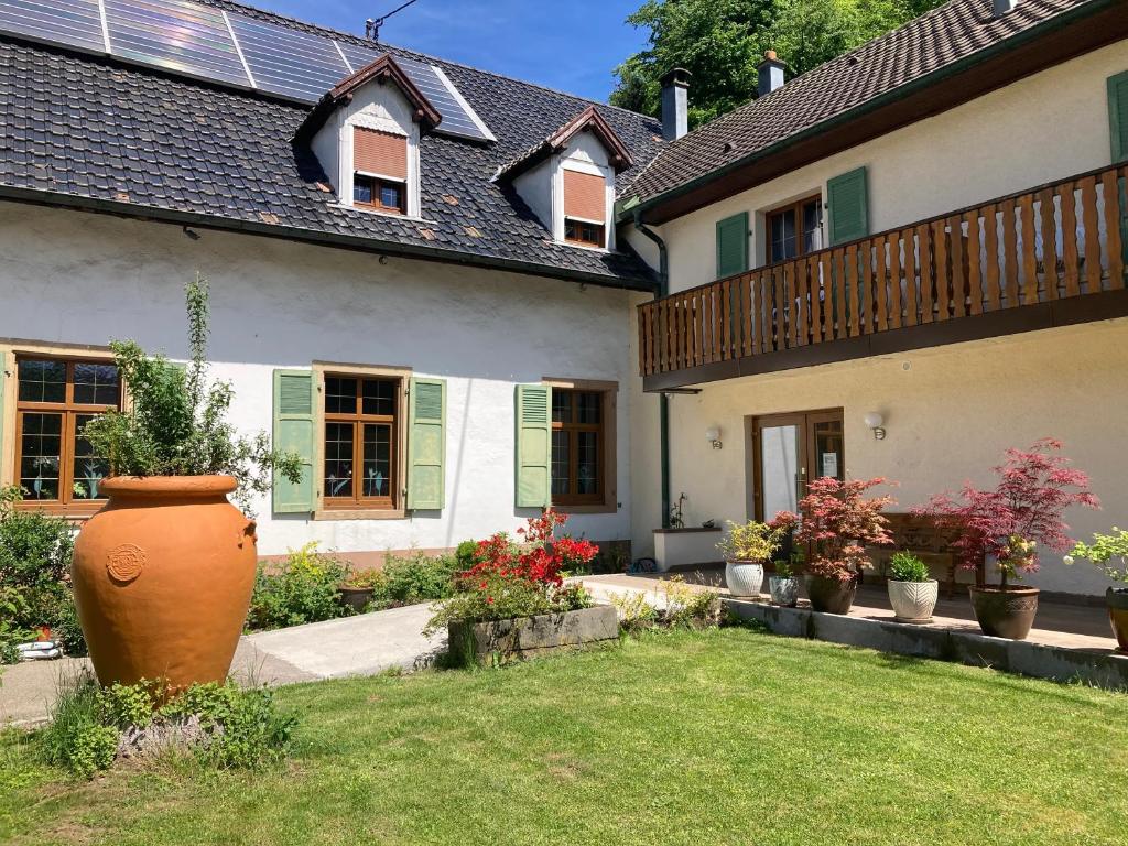 a large vase in the yard of a house at Auberge de France in Kruth