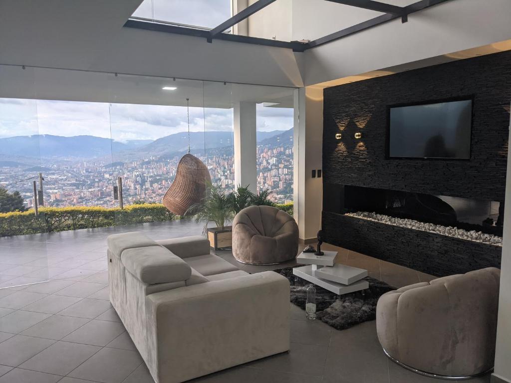 a living room with a couch and a tv at Nomad Finca in Envigado