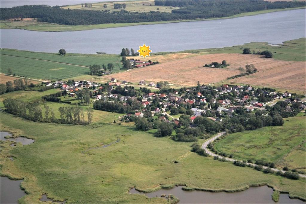 an aerial view of a small village on an island in the water at Boddenperle in Bresewitz