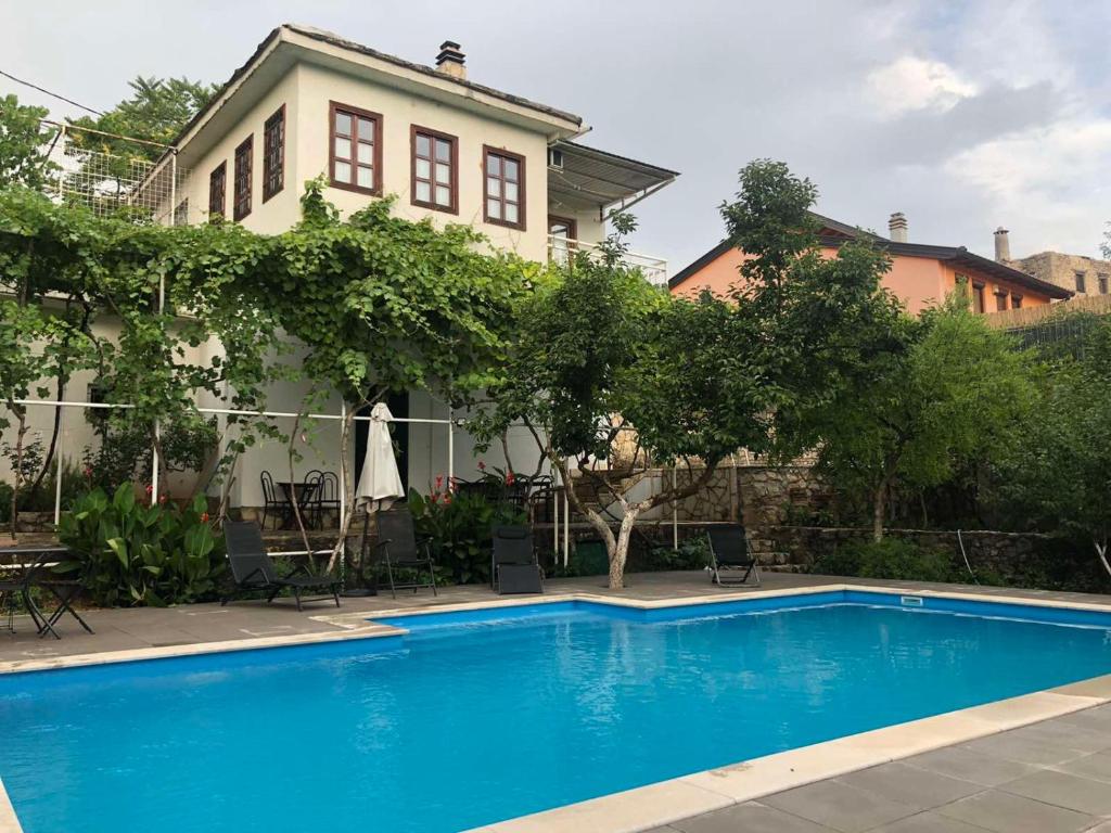 a swimming pool in front of a house at Holiday Home Iris in Blagaj