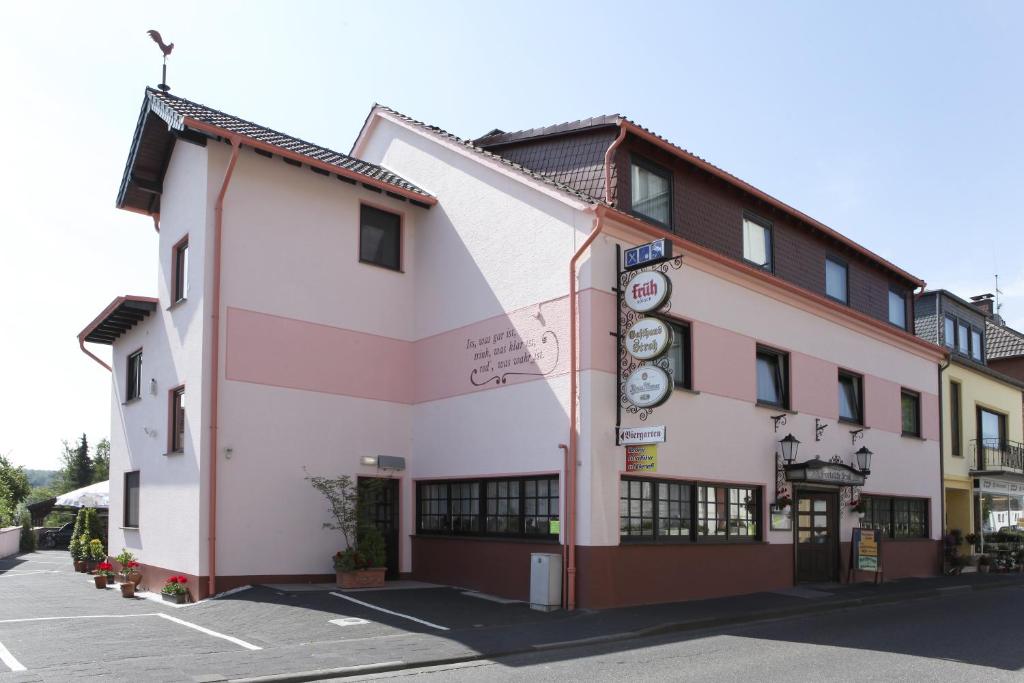 a building with a sign on the side of it at Gasthaus Stroh in Buchholz