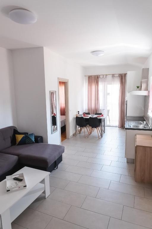a living room with a couch and a table at Apartments Time For Sea in Koper