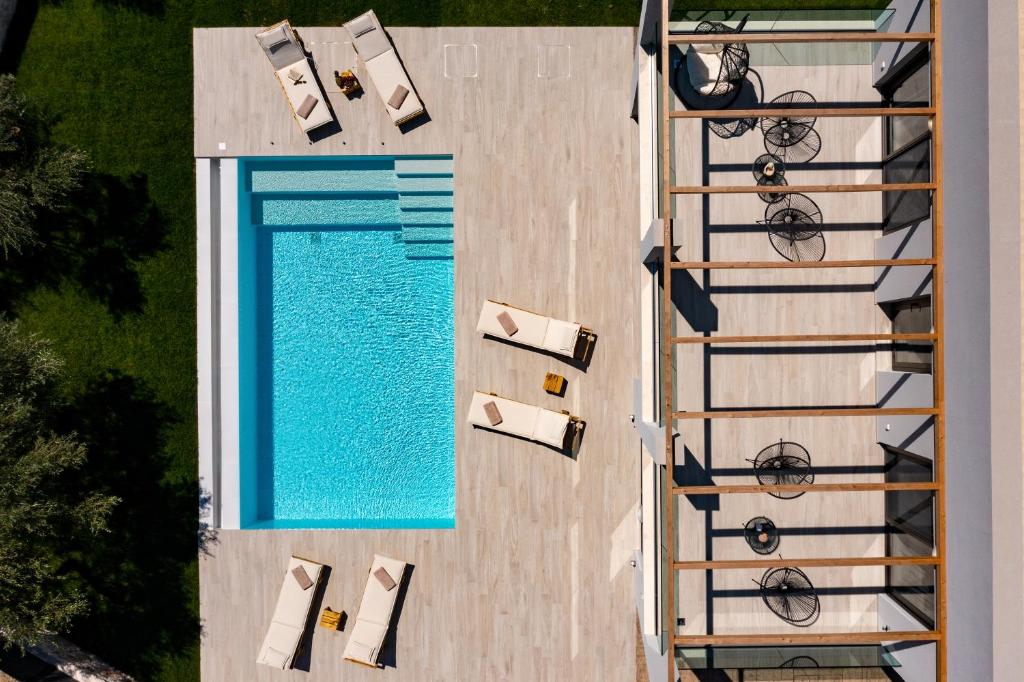 an overhead view of a swimming pool with lounges and chairs at Ariadne Elegant Villa in Psarou