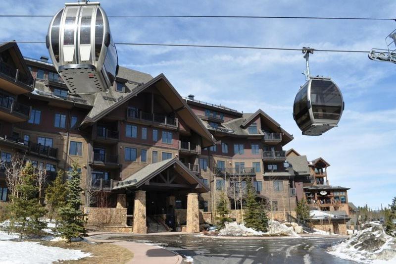 a ski lift in front of a large building at Crystal Peak Lodge 4 Bedroom Ski In, Ski Out Slopeside Condo At The Base Of Peak 7 in Breckenridge