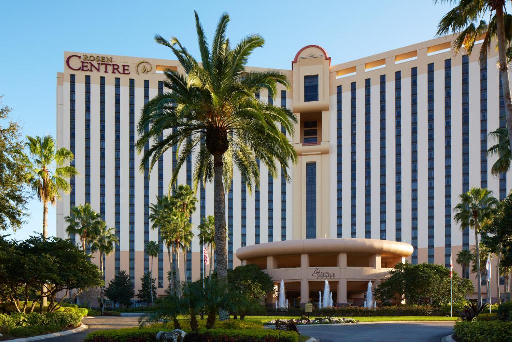 a large building with palm trees in front of it at Rosen Centre Hotel Orlando Convention Center in Orlando