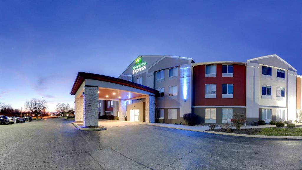 un edificio de hotel con un aparcamiento enfrente en Holiday Inn Express Fort Wayne - East - New Haven, an IHG Hotel, en New Haven