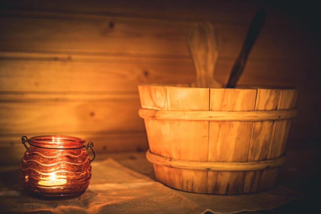 a candle and a wooden barrel on a table at Lillmåsen Naantali - atmospheric and very comfy studio in Naantali