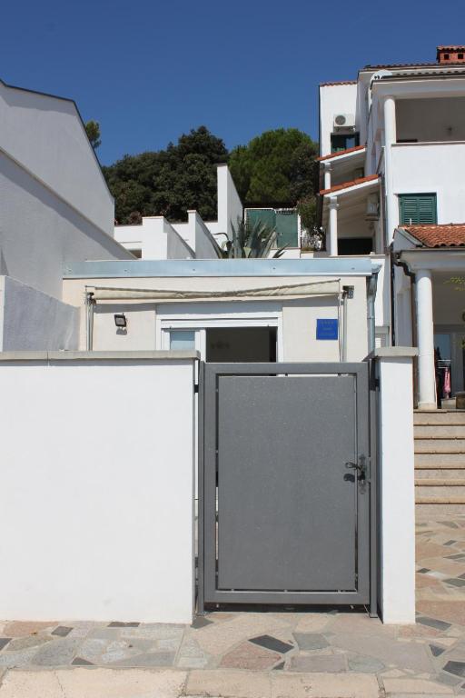 a door in the side of a white building at Apartments Estelle in Pula