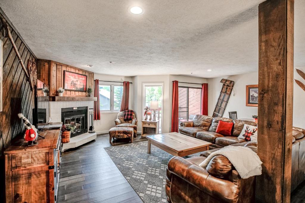 a living room with a couch and a fireplace at Cimarron Bear Condo: Fantastic Location, Sleeps 8 in Breckenridge