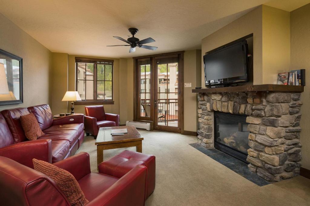 a living room with a fireplace and a flat screen tv at Purgatory Lodge Unit 306 in Durango Mountain Resort